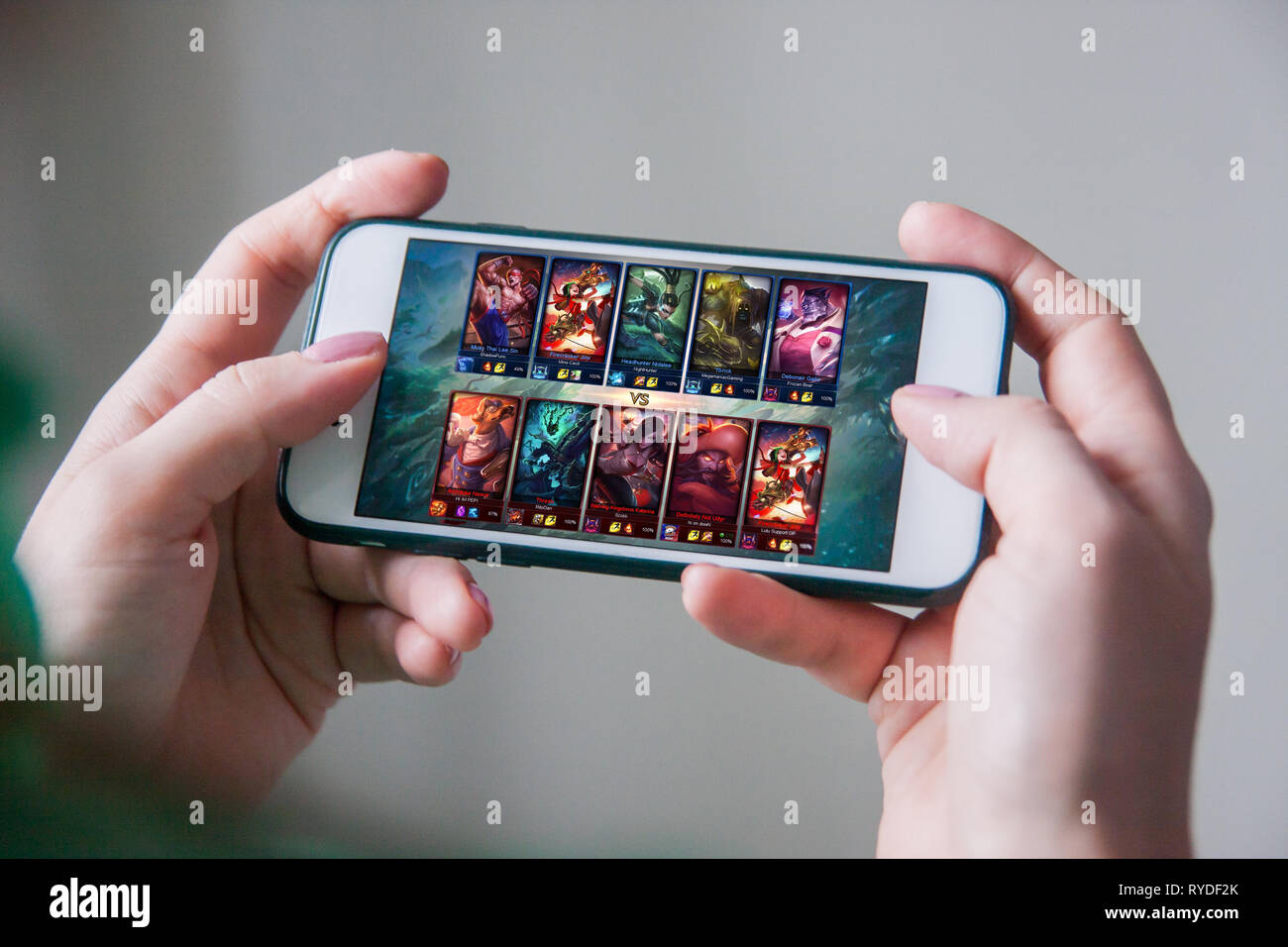 Los Angeles, California, USA - 25 February 2019: Hands holding a smartphone with League of Legends game on screen, Illustrative Editorial Stock Photo