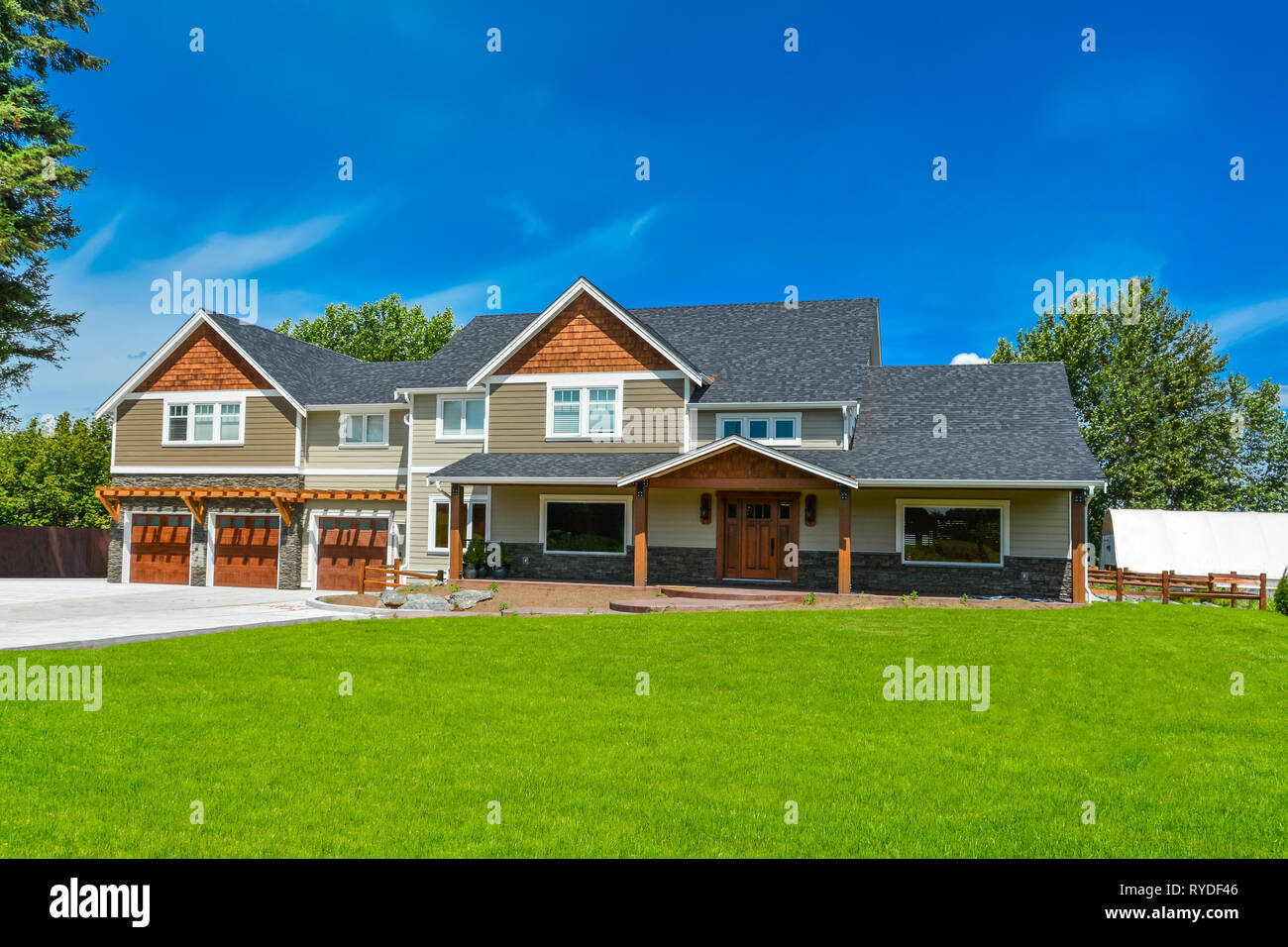 Brand new big farmer's house with three garage door and blue sky background  Stock Photo - Alamy, image size:1300x956