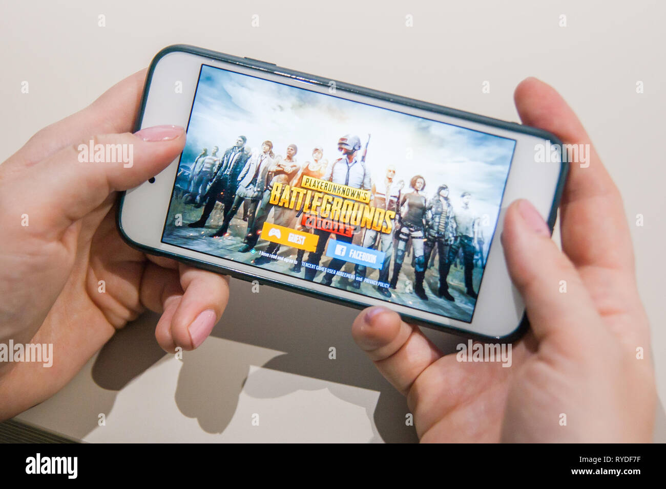 Los Angeles, California, USA - 25 February 2019: Hands holding a smartphone with PUBG Player Unknowns Battlegrounds game on screen, Illustrative Edito Stock Photo
