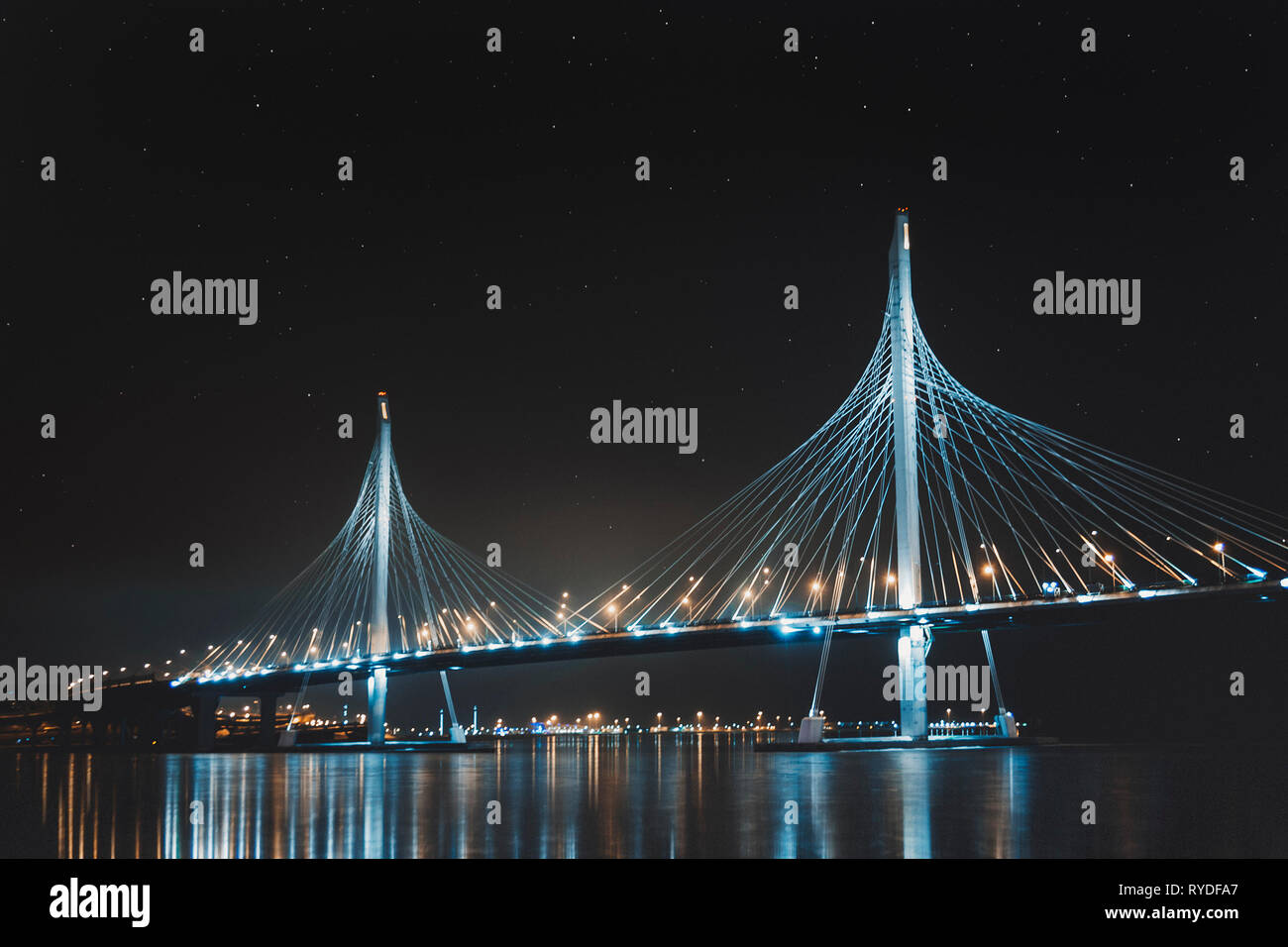 Beautiful cable-stayed bridge in St. Petersburg, Russia, with starry sky and city lights Stock Photo