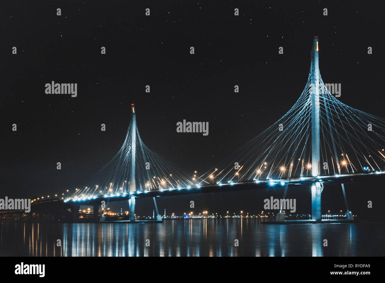 Beautiful cable-stayed bridge in St. Petersburg, Russia, with starry sky and city lights Stock Photo