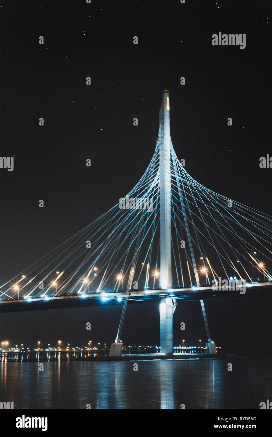Beautiful cable-stayed bridge in St. Petersburg, Russia, with starry sky and city lights Stock Photo