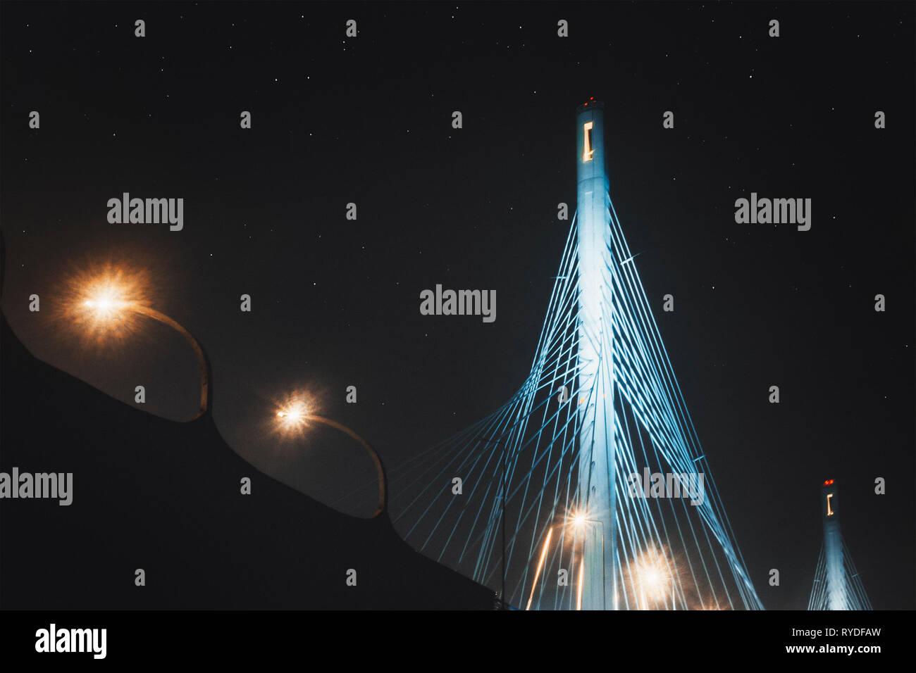 Beautiful cable-stayed bridge in St. Petersburg, Russia, with starry sky and city lights Stock Photo