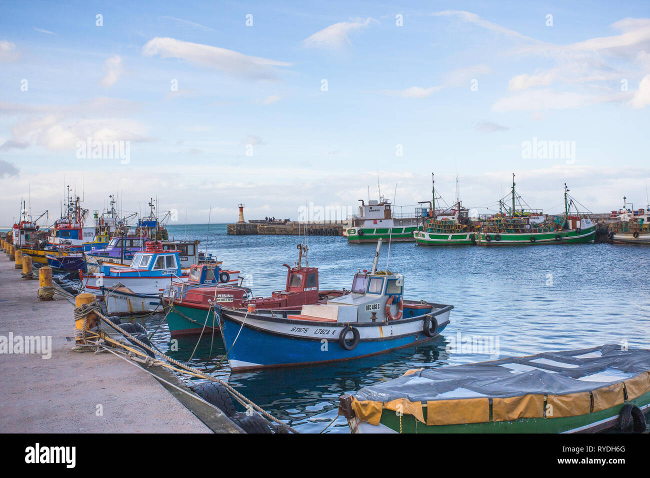 Fishing boats colourful or multicoloured moored for the evening at Kalk Bay harbour or harbor, False Bay, Cape Peninsula, South Africa Stock Photo