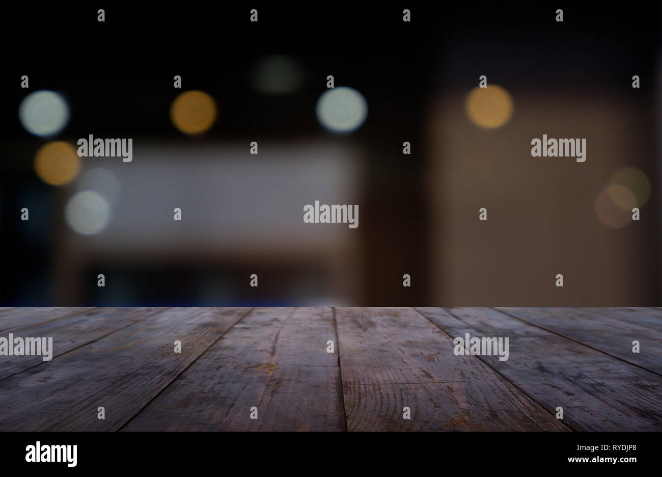 Empty dark wooden table in front of abstract blurred background of cafe ...