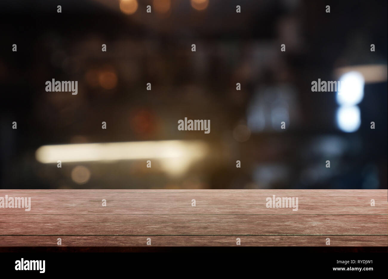 Empty dark wooden table in front of abstract blurred background of ...