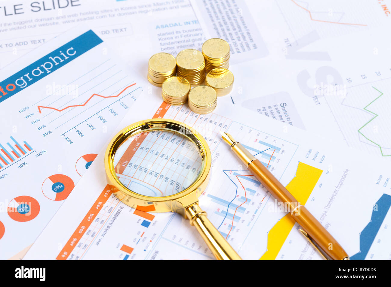 A magnifying glass and COINS Stock Photo - Alamy