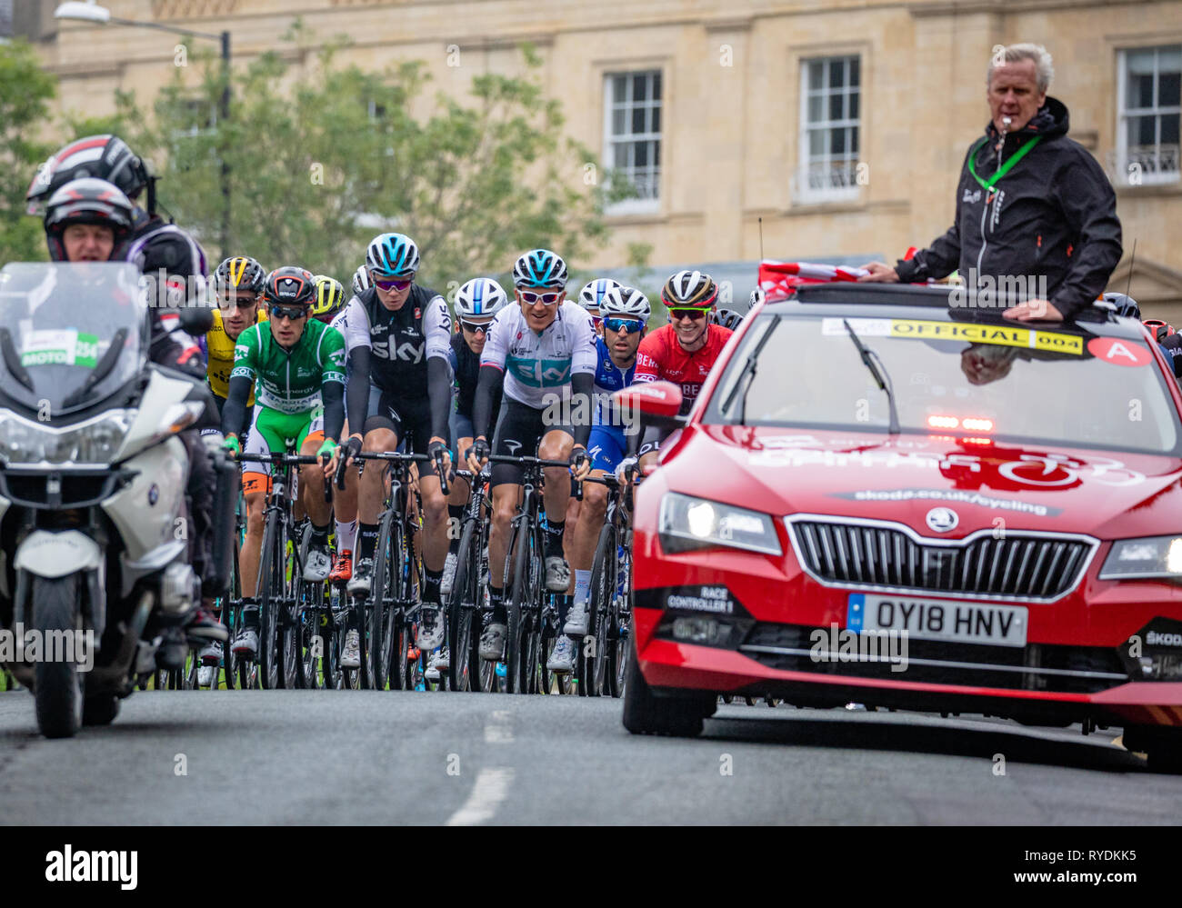 Official marshall car and peleton in the OVO Energy Tour of Britain bike race stage 3 as it passes through Clifton in Brstol UK on September 4th 2018 Stock Photo