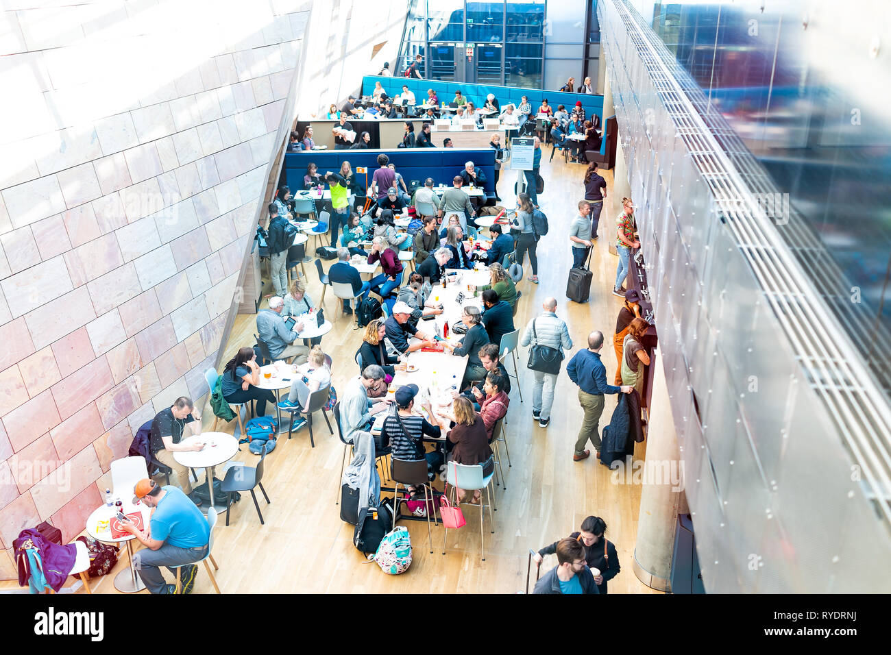 Keflavik, Iceland - June 20, 2018: Icelandair terminal cafe high angle view of people sitting at tables eating by restaurant in international airport  Stock Photo