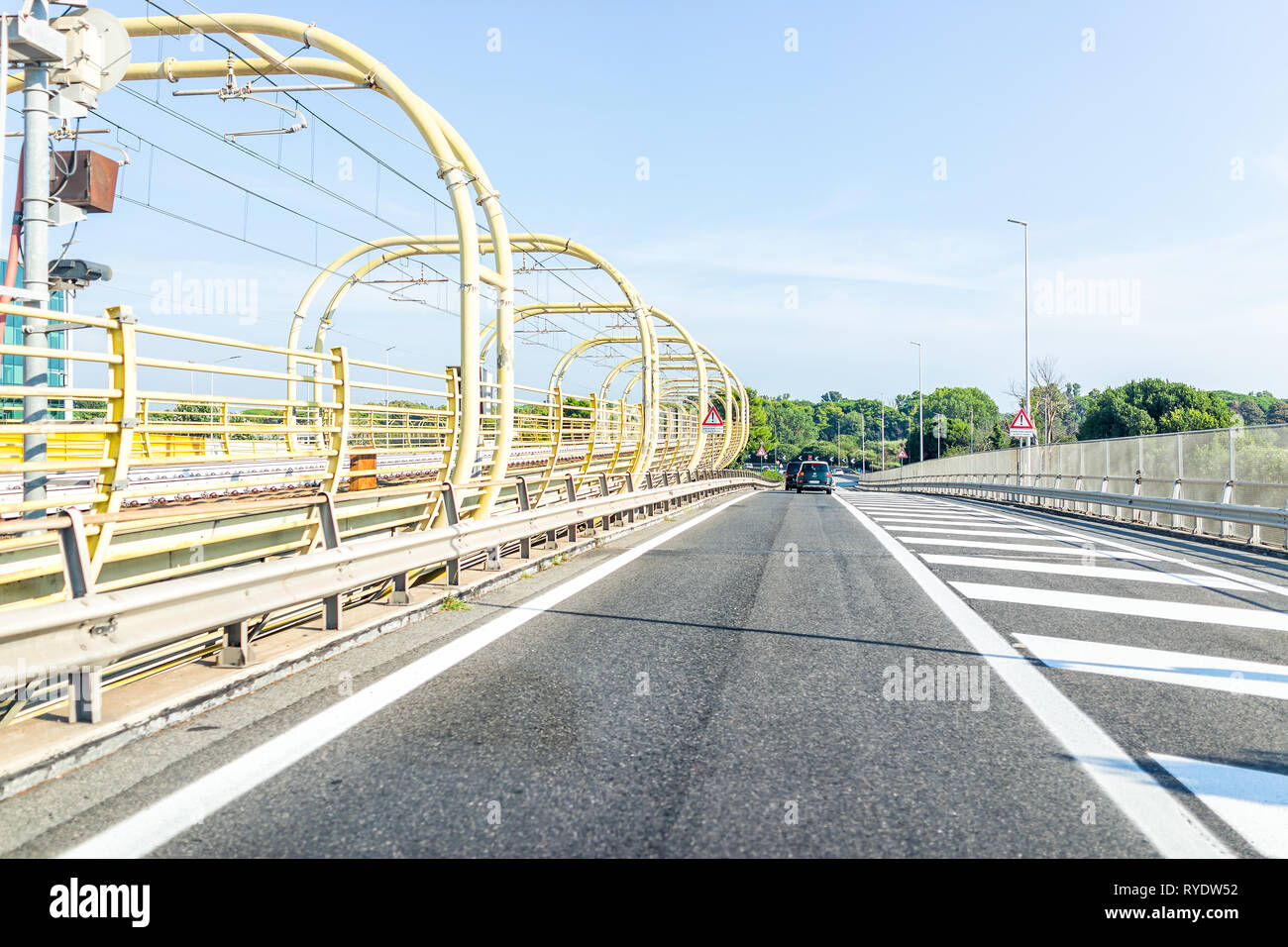 Rome, Italy - August 24, 2018: Sunny summer day and highway road street with modern autostrade and train rail Stock Photo