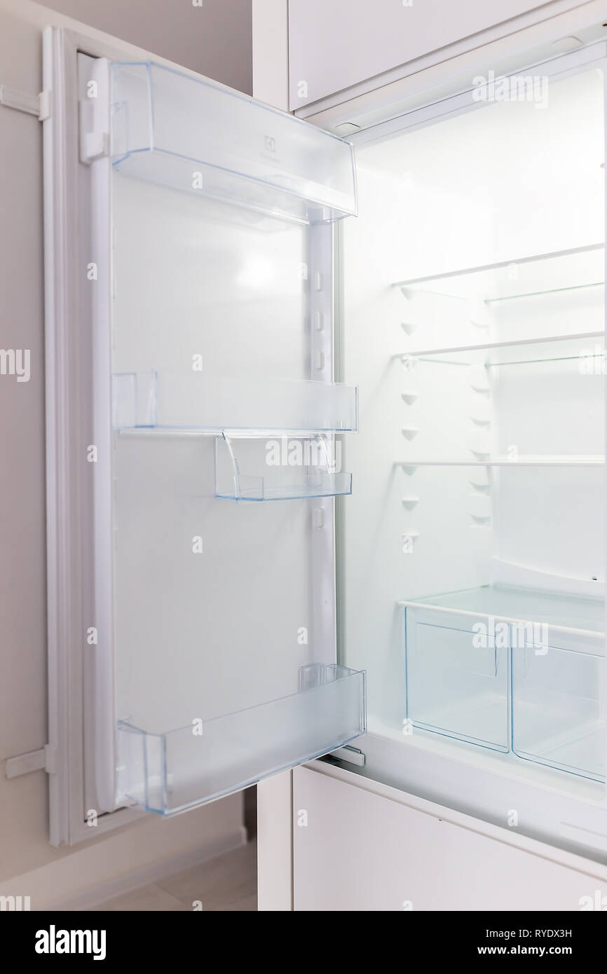 Open empty modern white kitchen refrigerator fridge inside interior vertical closeup of appliance Stock Photo