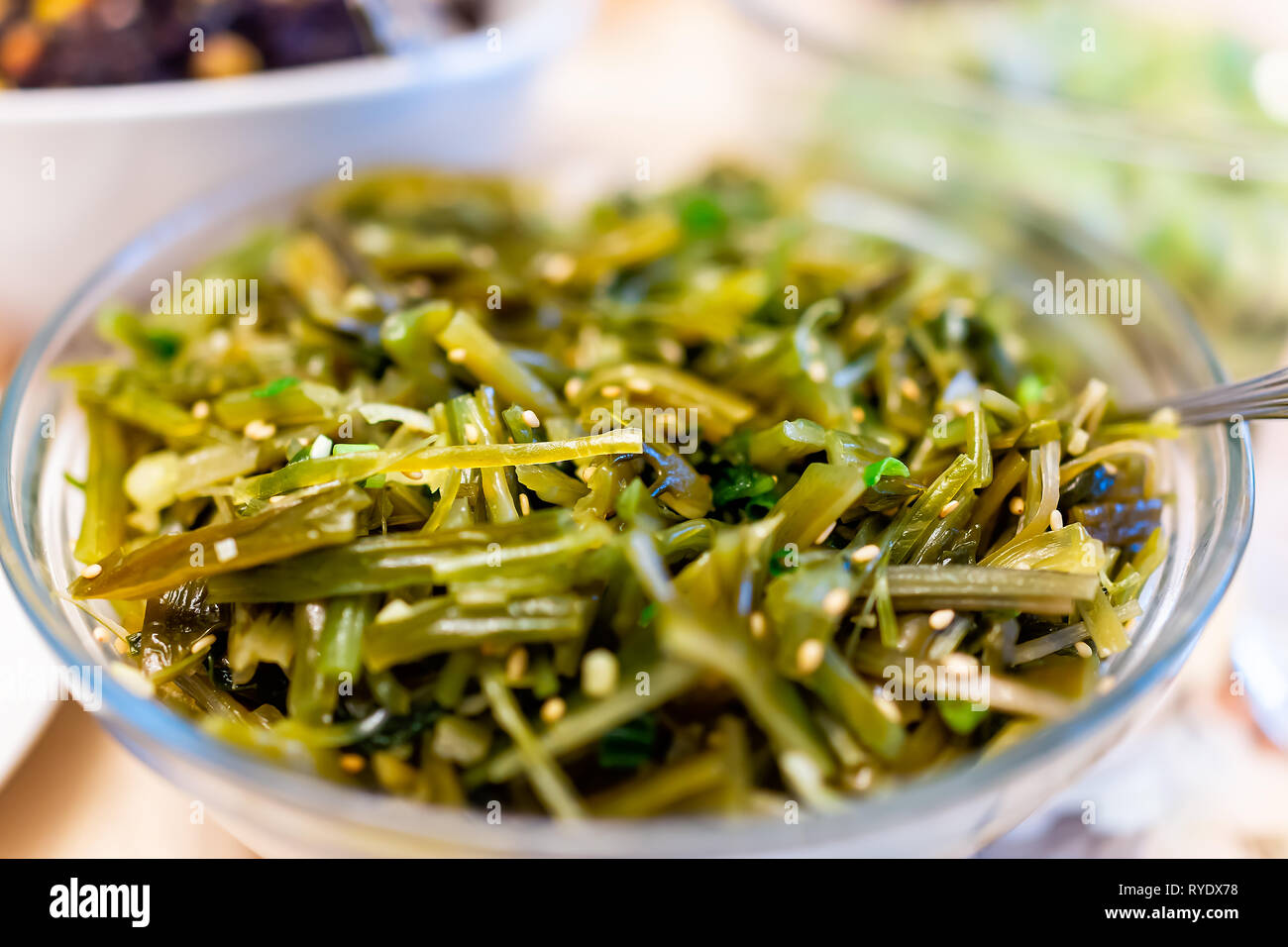 Macro closeup of Asian seaweed salad with chopped green brown kelp sea