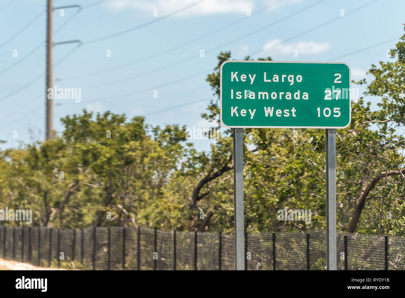 Green road sign for Key Largo, Islamorada and Key west island along Overseas highway in Florida isolated on street Stock Photo