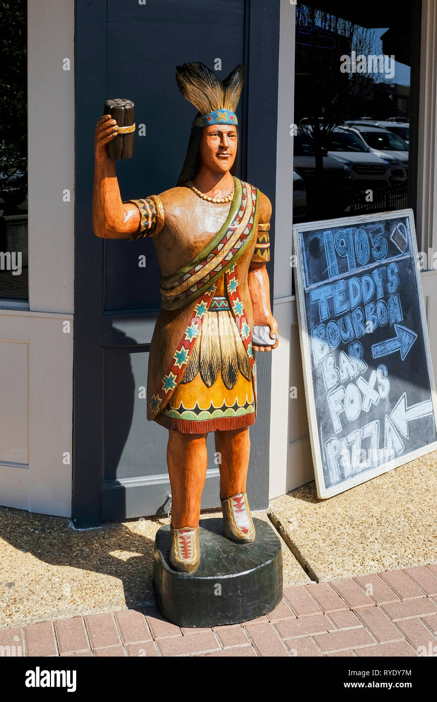 Cigar store indian or wooden indian stands in front of  a business in Prattville Alabama, USA. Stock Photo