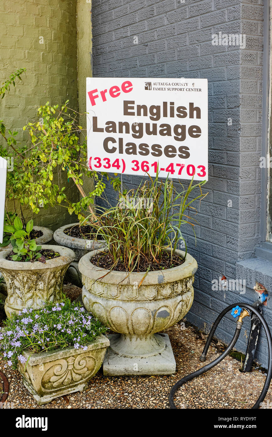 English language classes sign in a flower pot near a busy sidewalk in Prattville Alabama, USA. Stock Photo