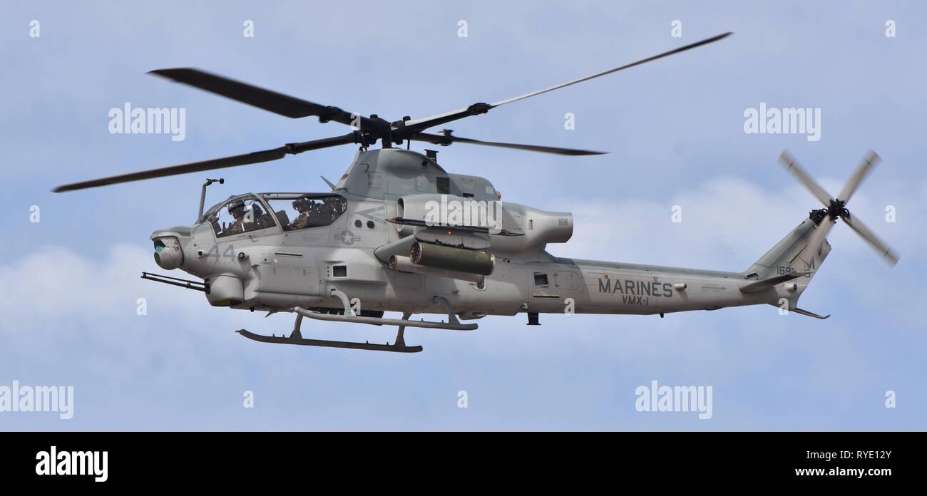 A U.S. Marine Corps AH-1Z Viper attack helicopter flying at MCAS Yuma. This AH-1Z Viper belongs to the VMX-1 squadron. Stock Photo