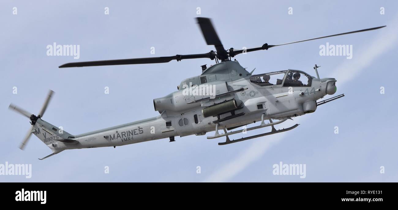 A U.S. Marine Corps AH-1Z Viper attack helicopter flying at MCAS Yuma. This AH-1Z Viper belongs to the VMX-1 squadron. Stock Photo