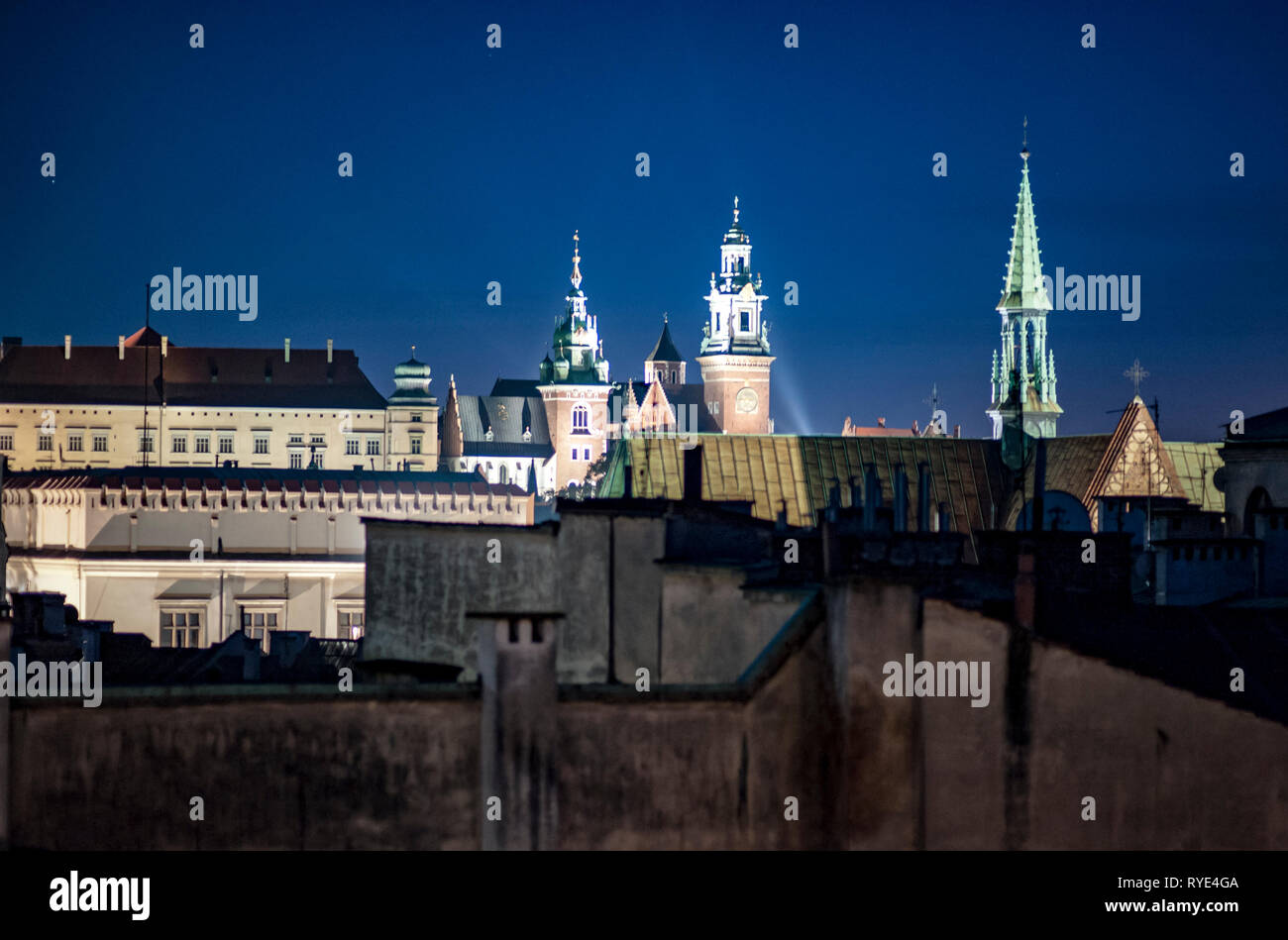 Nightime landscape depicting the skyline of Cracow, Poland with lights and reflections Stock Photo