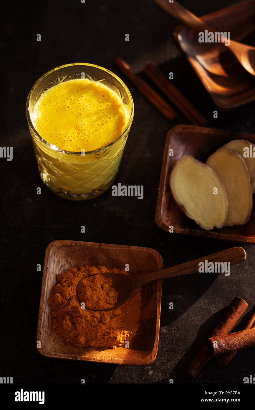 Fresh homemade golden milk with turmeric, cinnamon and honey Stock