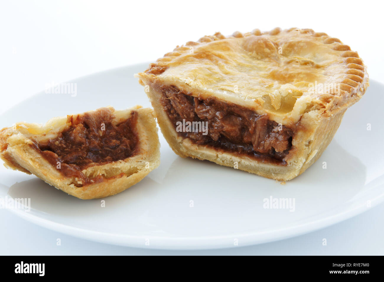 Savoury meat pie with a beef filling on a white plate Stock Photo Alamy