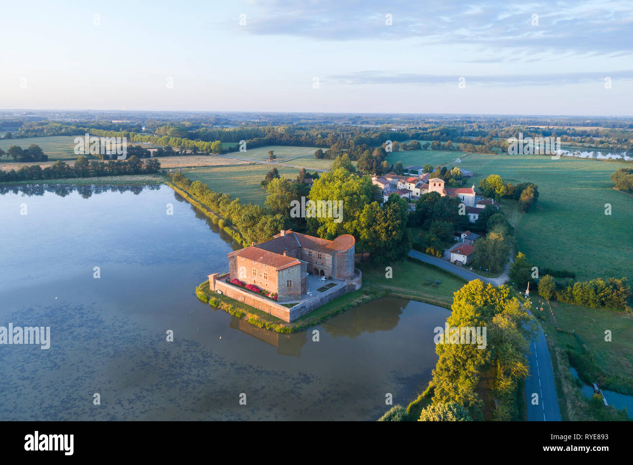 France, Ain, The Dombes region, Bouligneux, the village and the castle at the edge of the Castle pond (aerial view) // France, Ain (01), la Dombes, Bo Stock Photo
