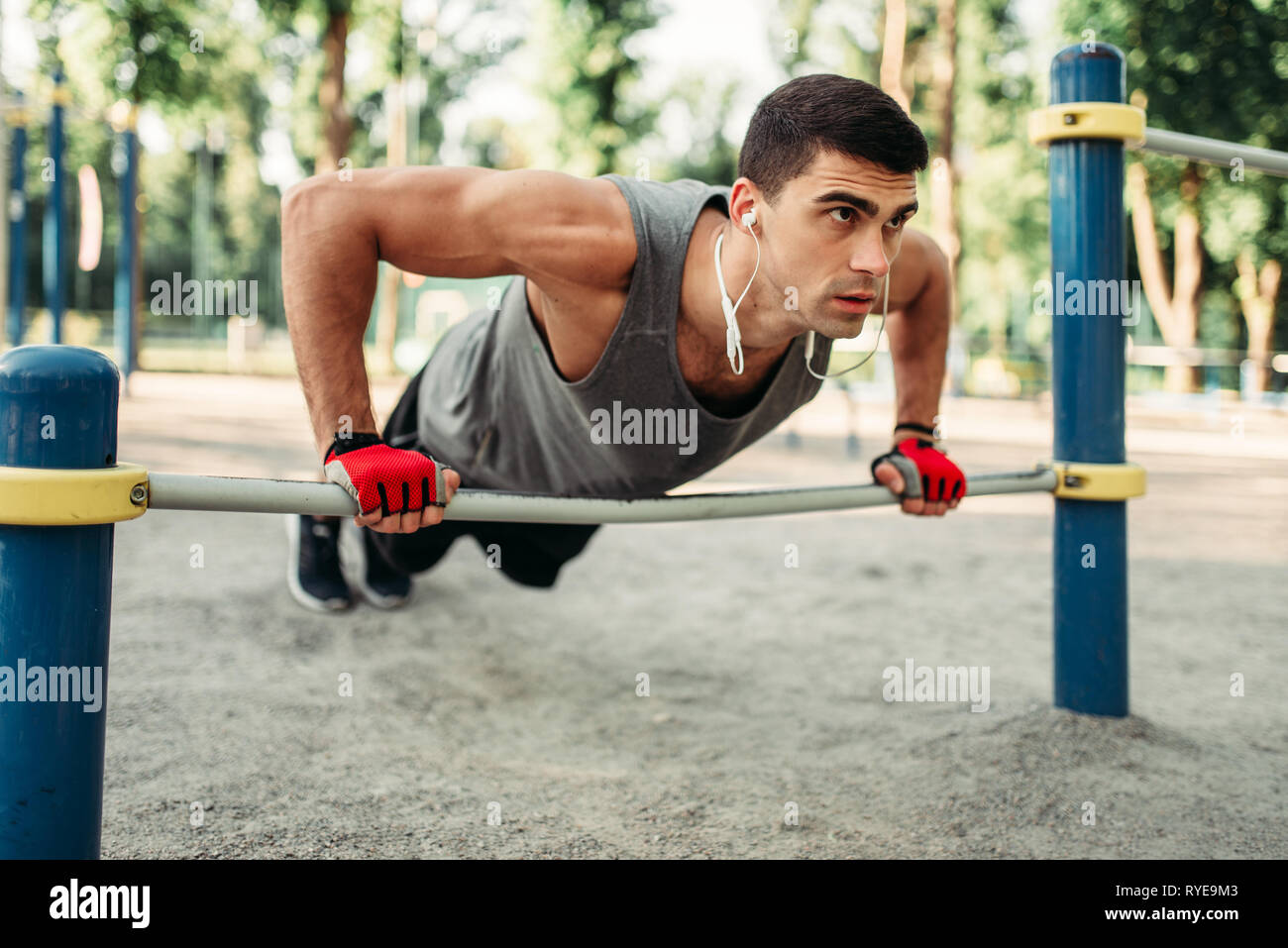 Man doing push up exercise using horizontal bar Stock Photo Alamy