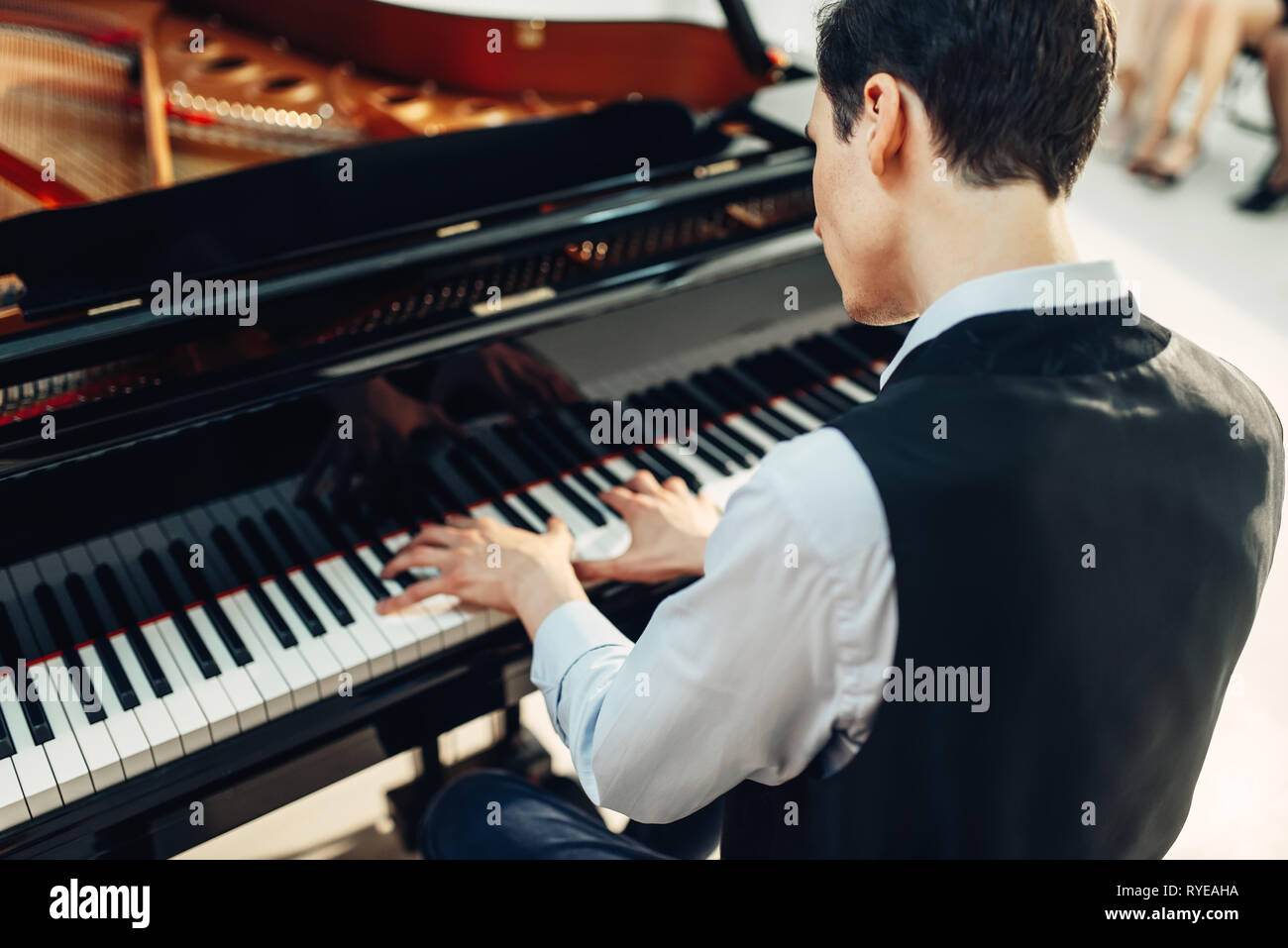 Pianist playing music on grand piano Stock Photo - Alamy