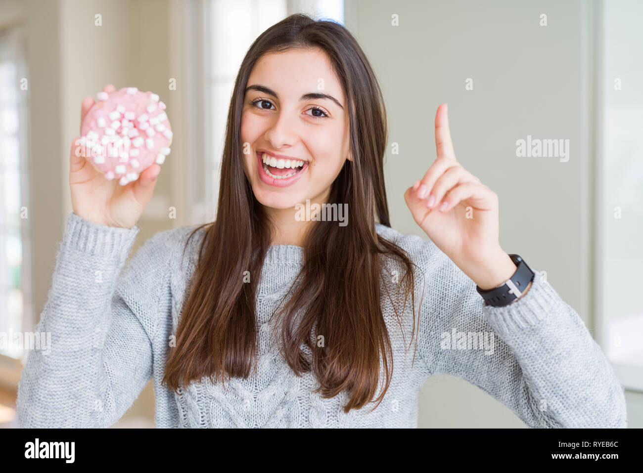 Beautiful Young Woman Eating Sugar Marshmallow Pink Donut Surprised With An Idea Or Question 