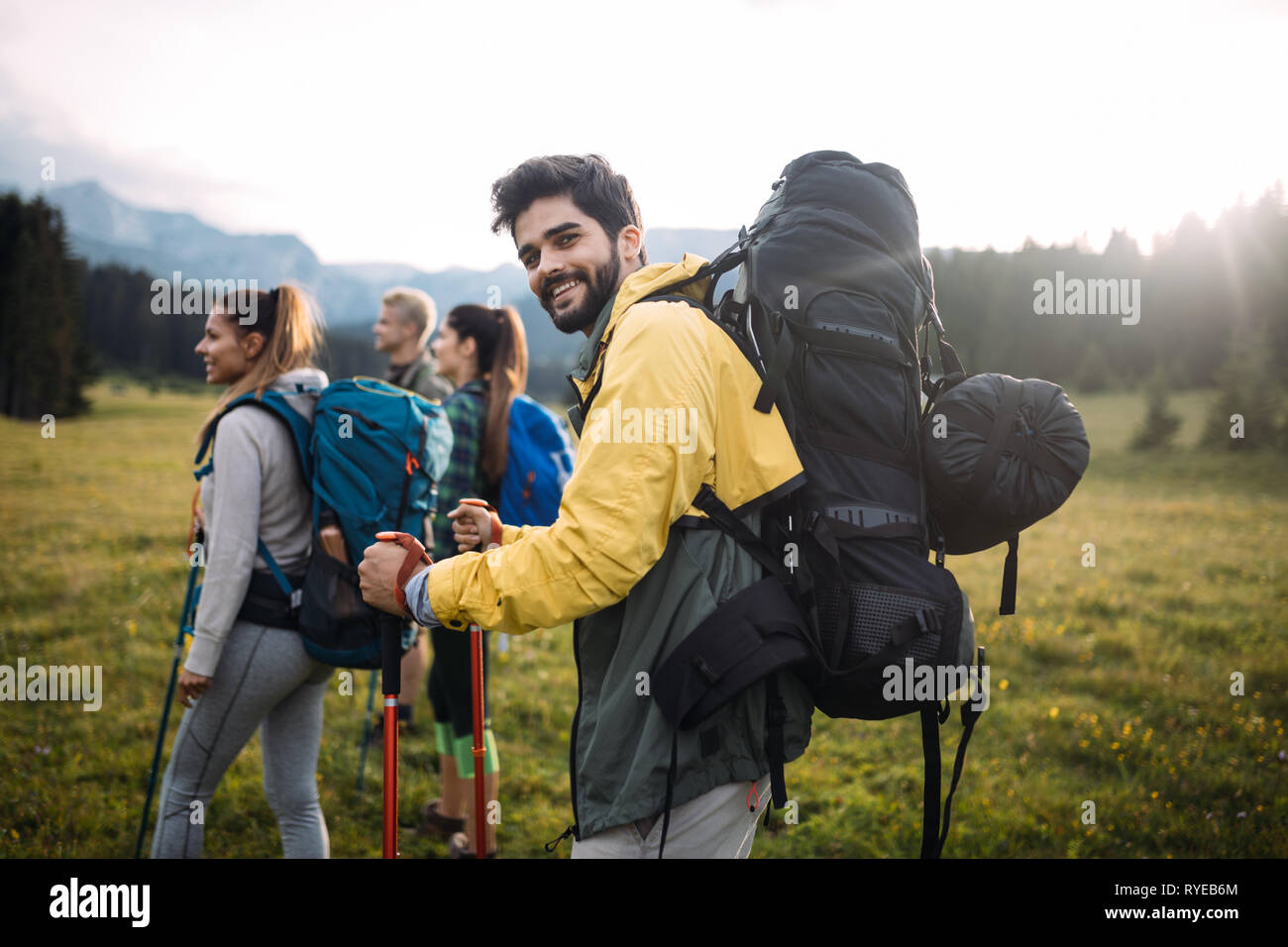 Young friends on a country walk. Group of people hiking through ...