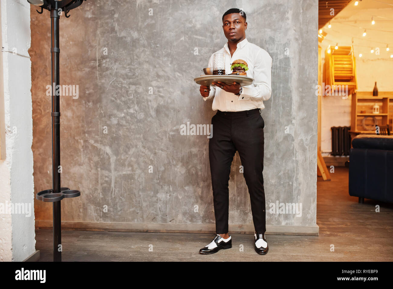 Waitressing Man Young african american waiter man hold tray with burger at restaurant ...