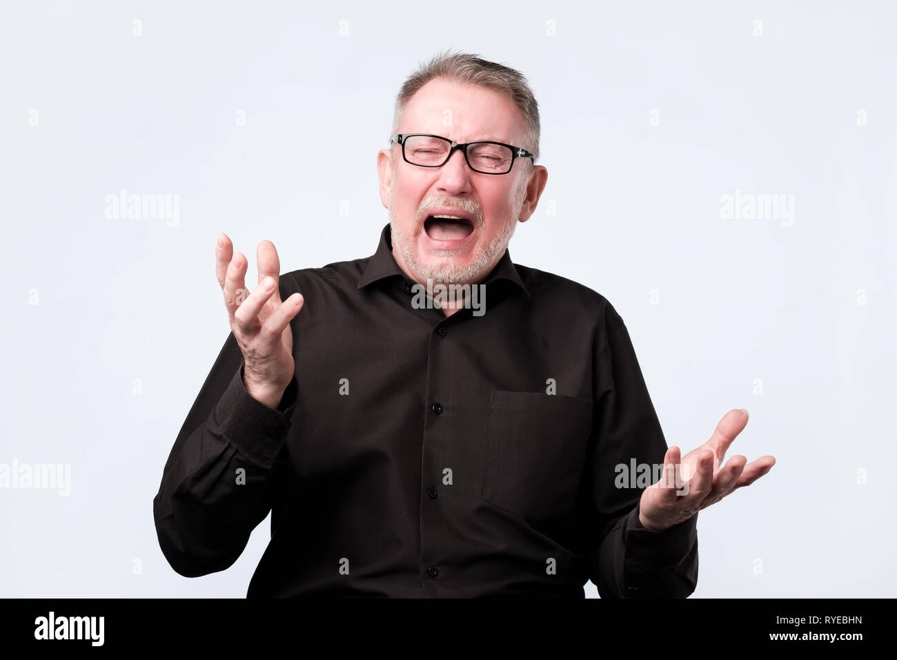Angry shocked man screaming, isolated on white background. Stock Photo
