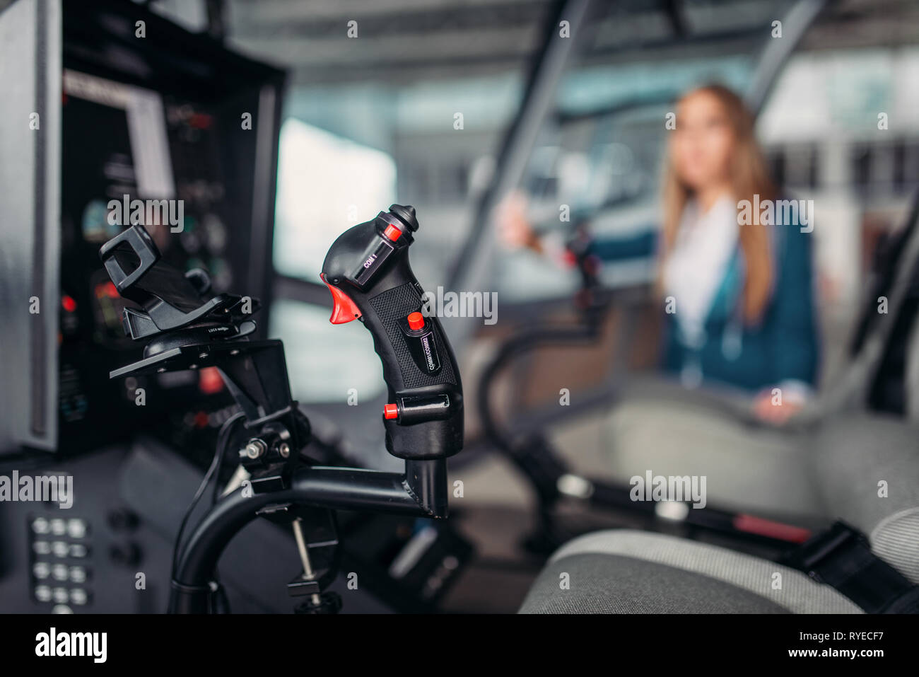 Stewardess poses in helicopter, view from cabin Stock Photo