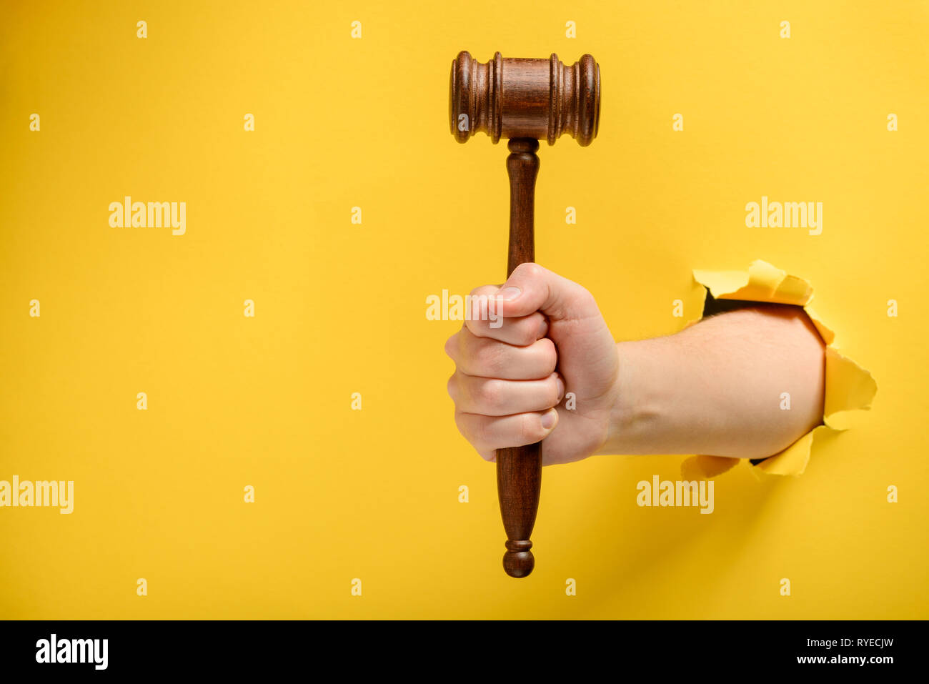 Auctioneer hold gavel in hand. Buyers raising arm holding bid paddles By  Tartila