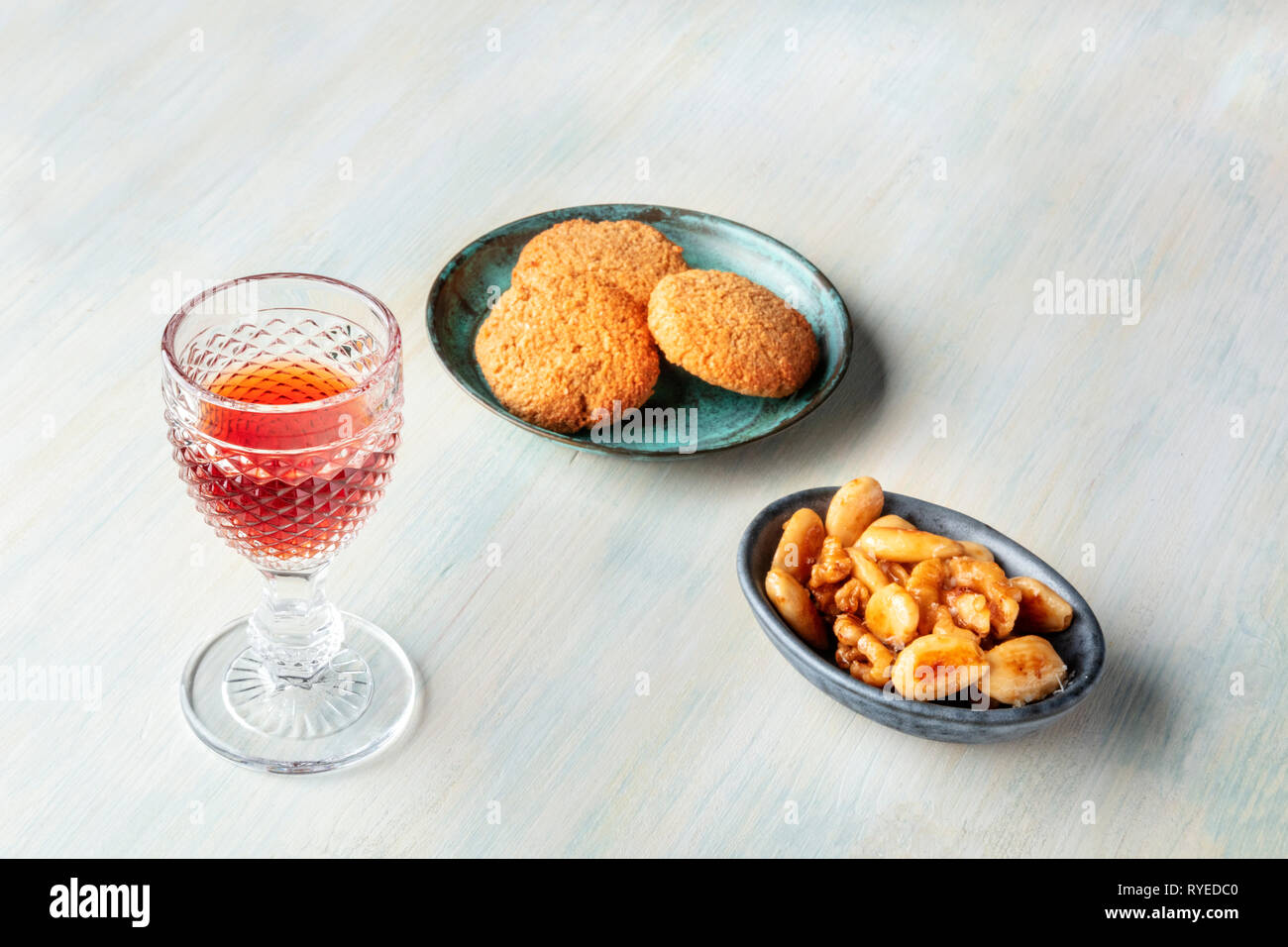 A glass of sweet wine with biscuits and nuts, with copy space Stock Photo