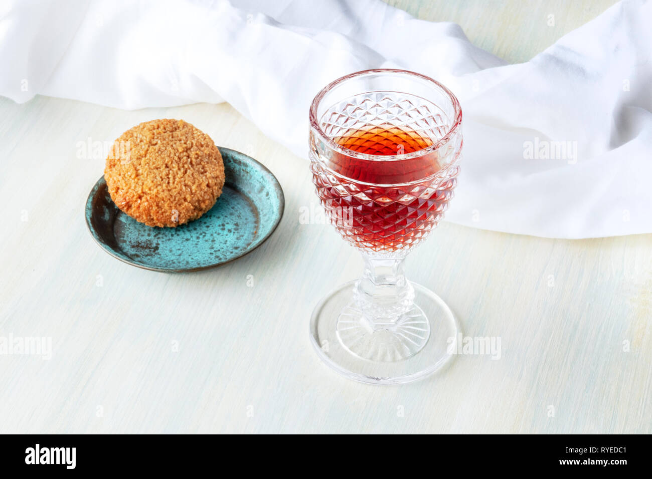 A glass of sweet wine with a cookie and copy space Stock Photo