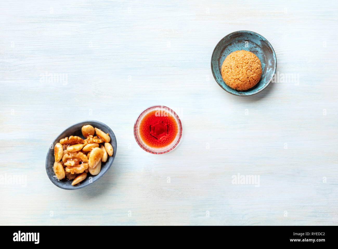 A glass of sweet wine with cookies and nuts, shot from the top with a place for text Stock Photo