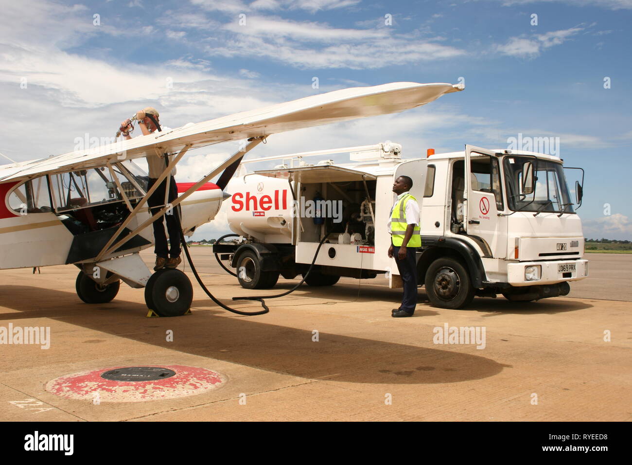 A light aircraft being refuelled at Entebbe International Airport, Uganda. Stock Photo