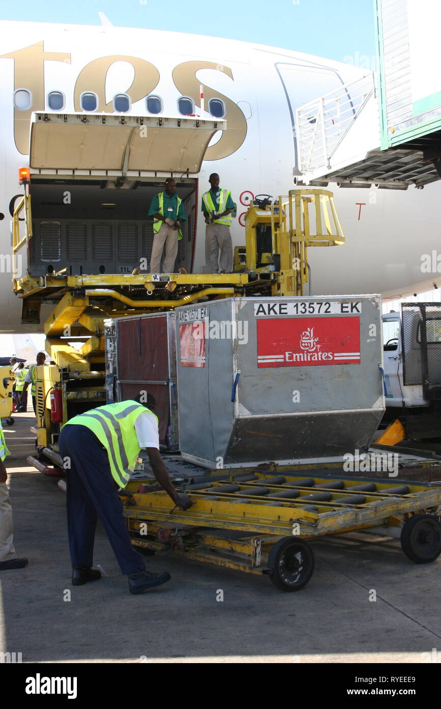 Cargo being loaded onto an Emirates aircraft at Entebbe International Airport, Uganda. Stock Photo