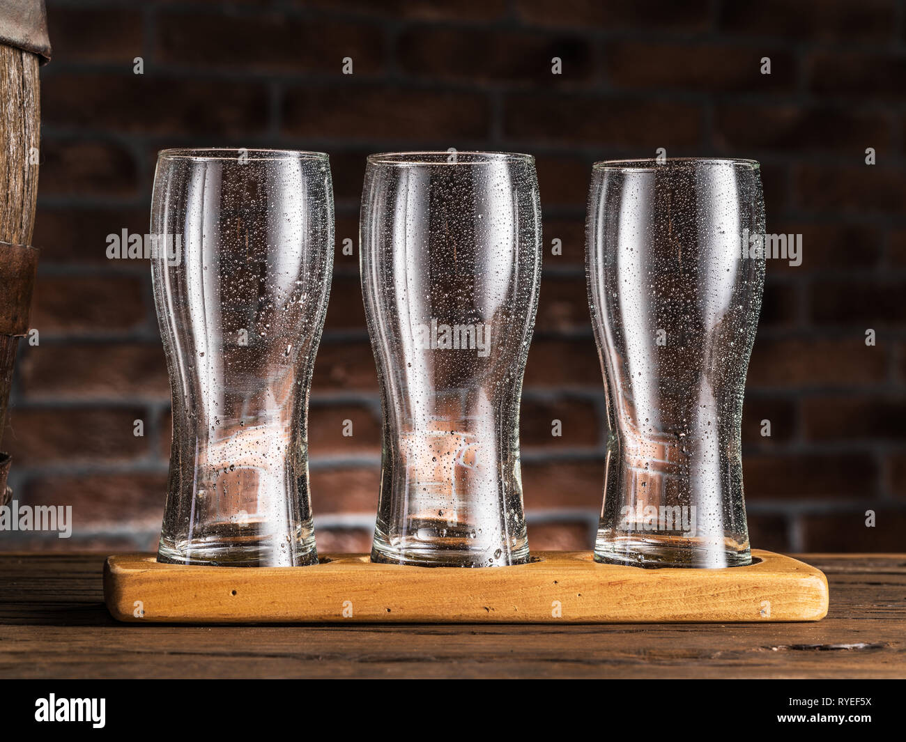 https://c8.alamy.com/comp/RYEF5X/empty-beer-glasses-near-a-cask-on-wooden-table-craft-brewery-RYEF5X.jpg