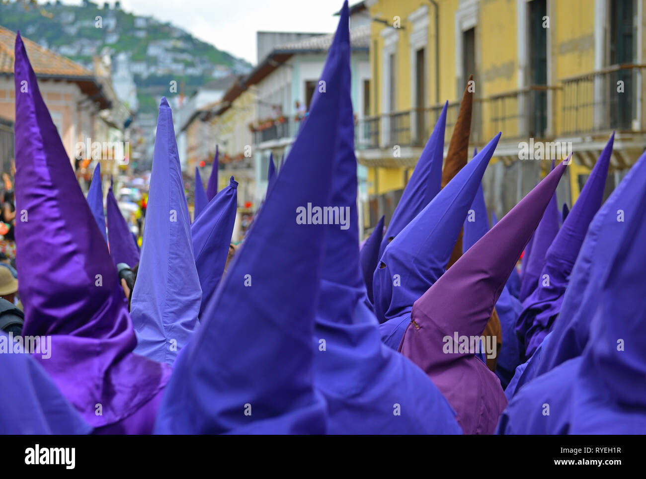 The purple penitents called the cucuruchos walking in the streets of Quito during the Easter procession in purple clothing on Holy Friday, Ecuador. Stock Photo