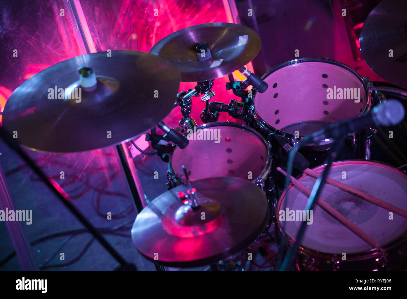 Rock music background with drum set in purple stage lights, close-up photo, soft selective focus Stock Photo