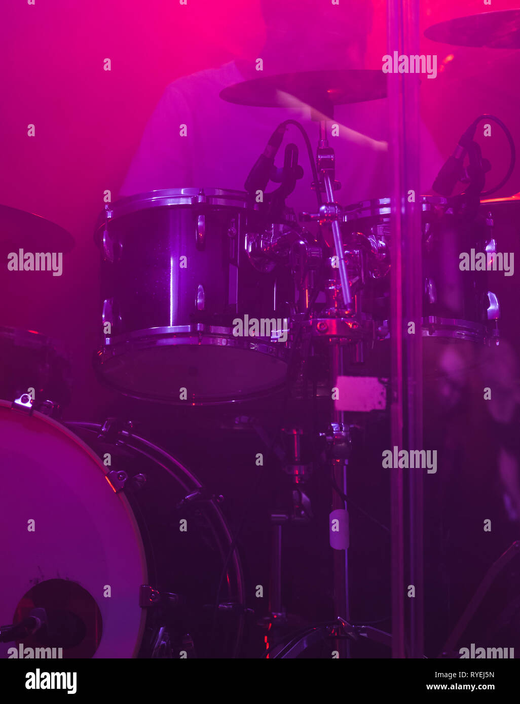 Live music vertical photo background, rock drum set with cymbals in purple stage light. Closeup photo, soft selective focus Stock Photo