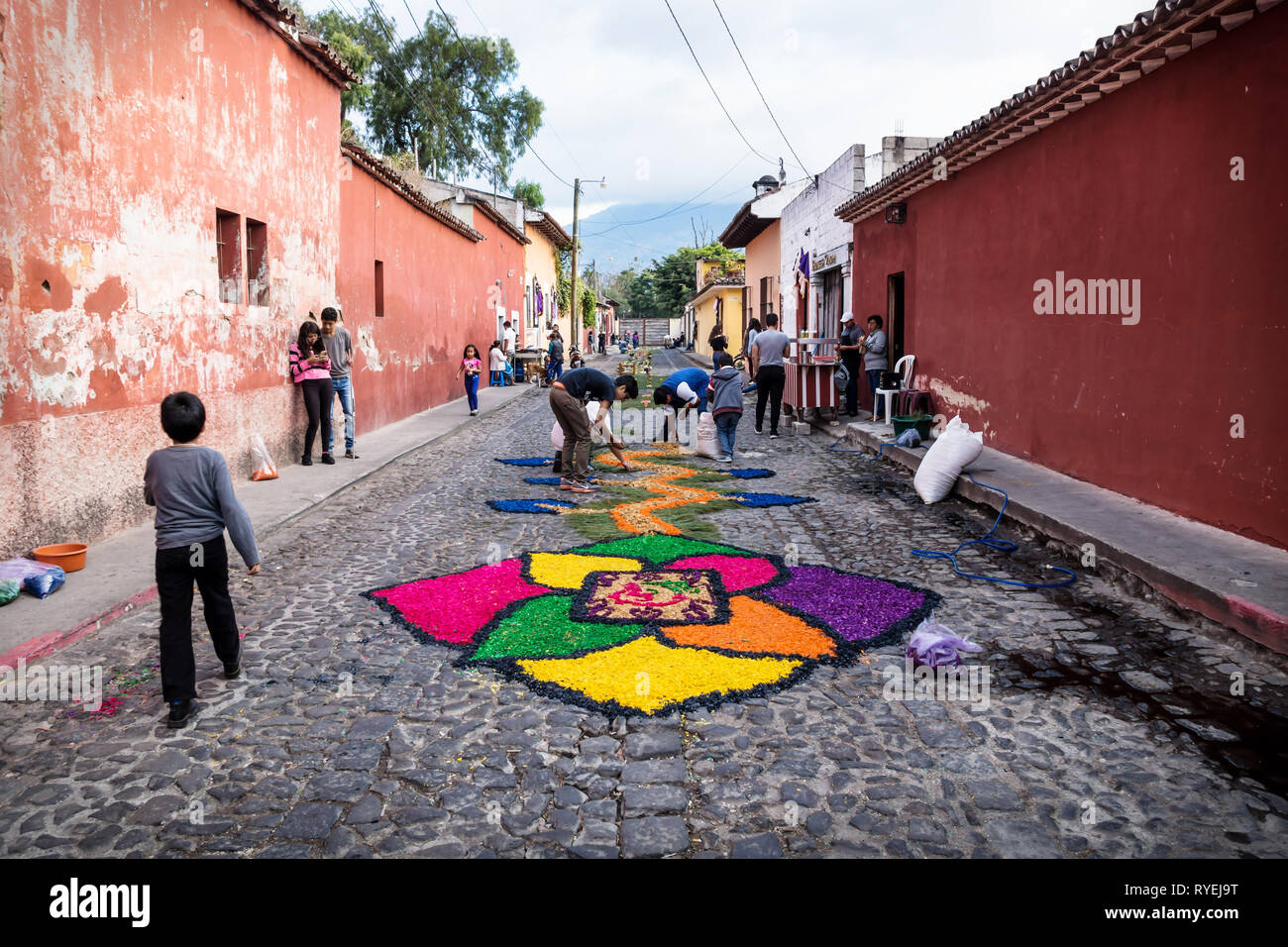 Antigua, Guatamala - 23 March 2018: People making alfombre colourful flower carpets on the cobbled streets Stock Photo