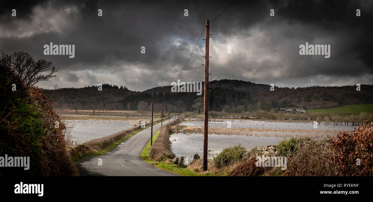 The road called 'The Causeway' crosses the Rusland Valley towards it's mouth, usually crossing fields... but with the storm rolling in at present the  Stock Photo