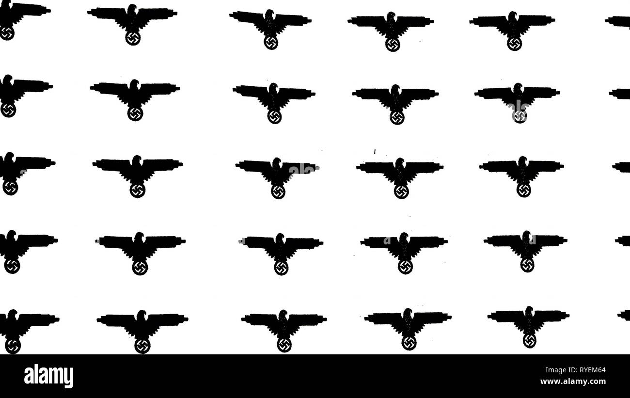Lots of black bird symbol of nazis on the wall that is color white from the WorldWar II history Stock Photo