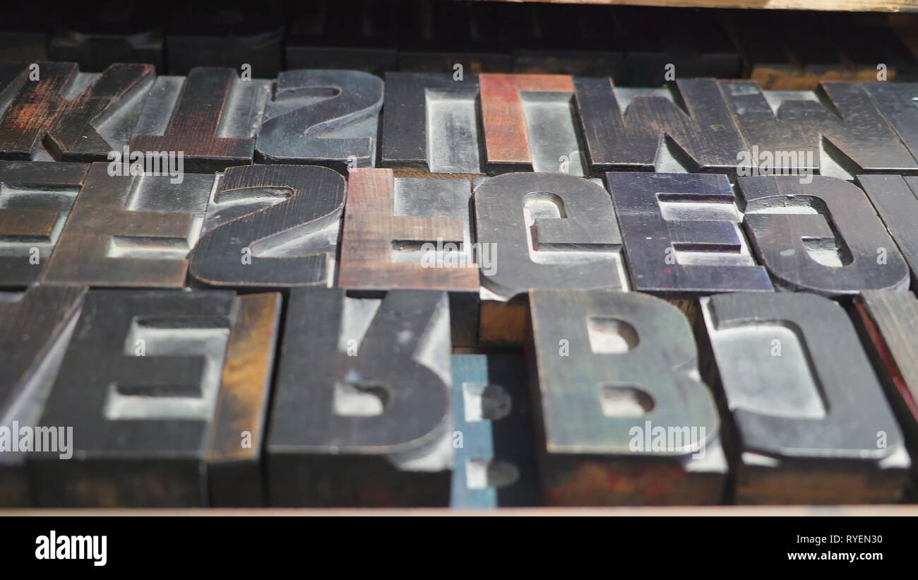 The upside down letter old stamps from the printing machine inside the