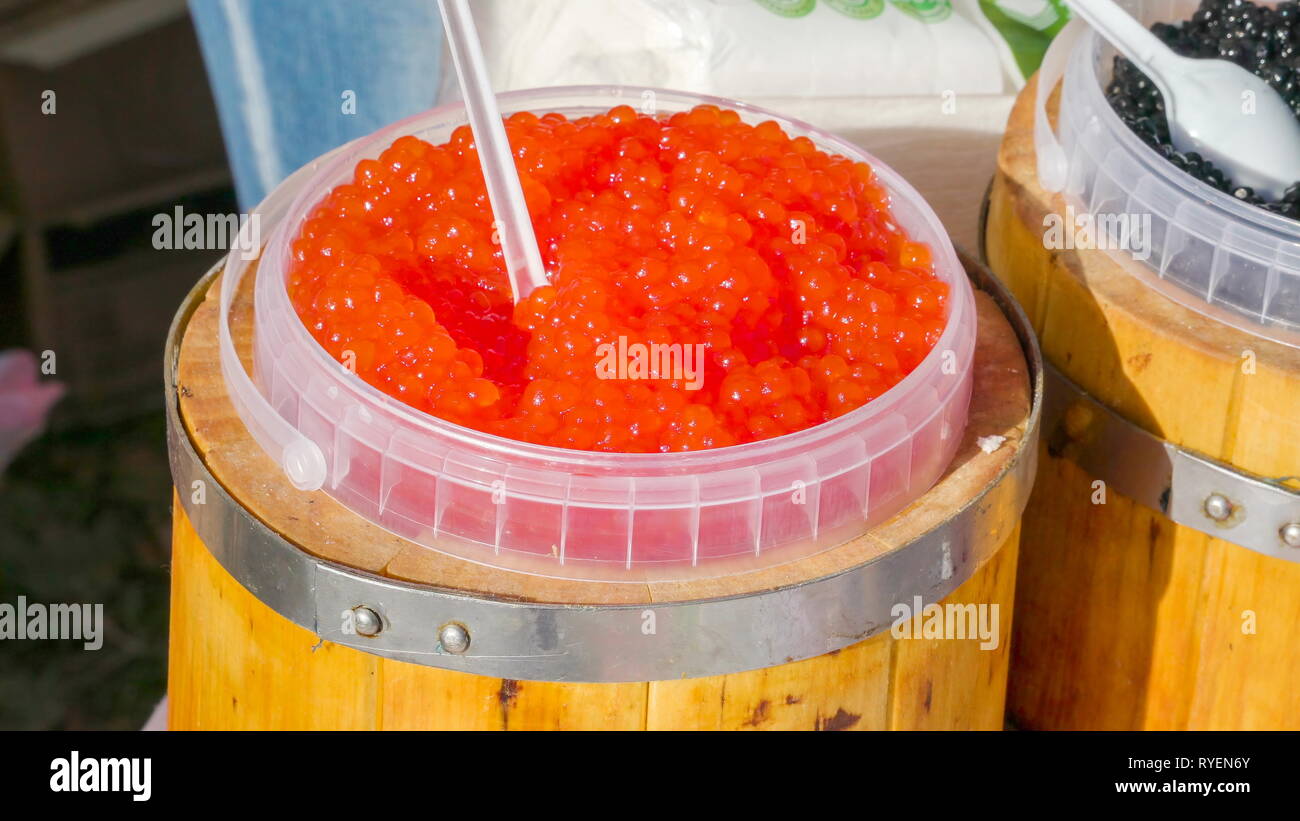 The orange colored caviar inside the jug beside it is the black color