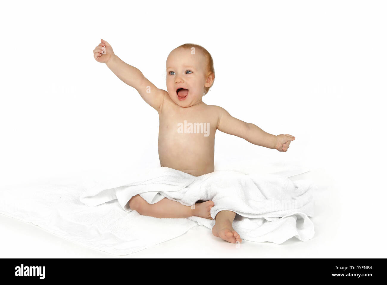 Happy infant in powerful pose Stock Photo