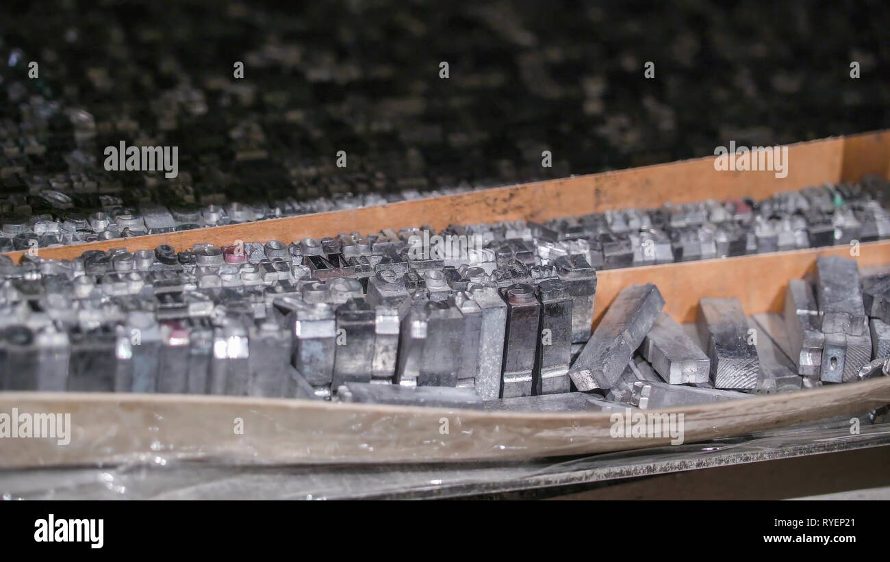 The metal stamps on top of the tray inside the old printing machine Stock Photo