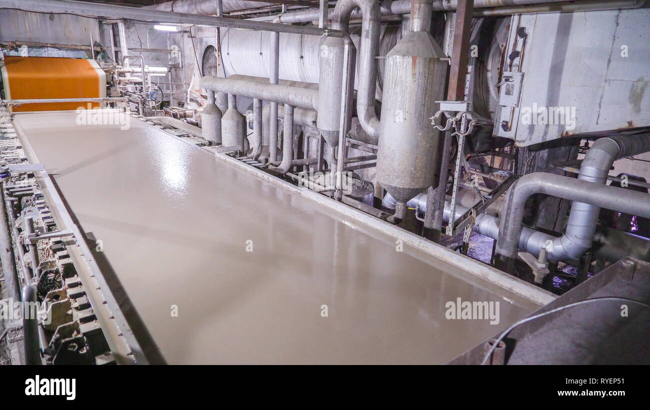 The big pipe tubes on the machinery inside the paper mill in Rapina